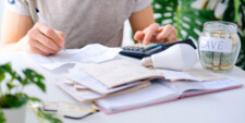 Mental health professional doing billing paperwork at desk.